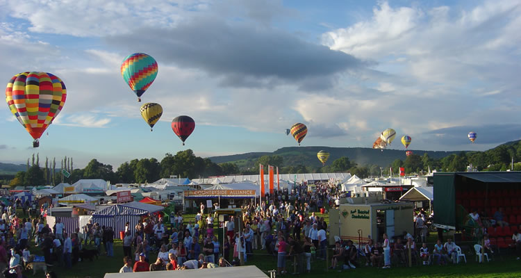 Hot air balloons over the Chatsworth Country Fair trade stands
